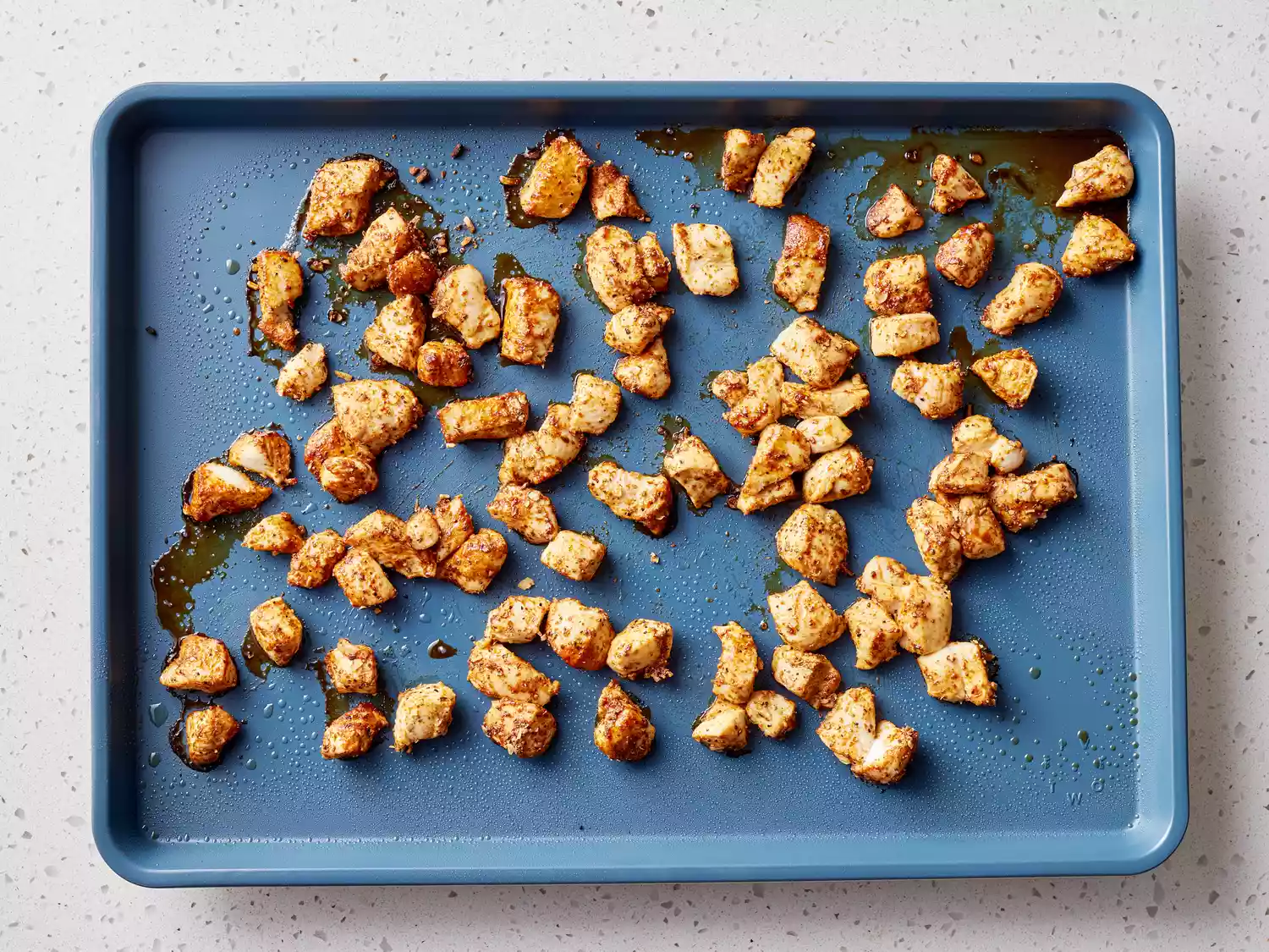 chicken pieces tossed with fajita seasoning and baked on a baking sheet