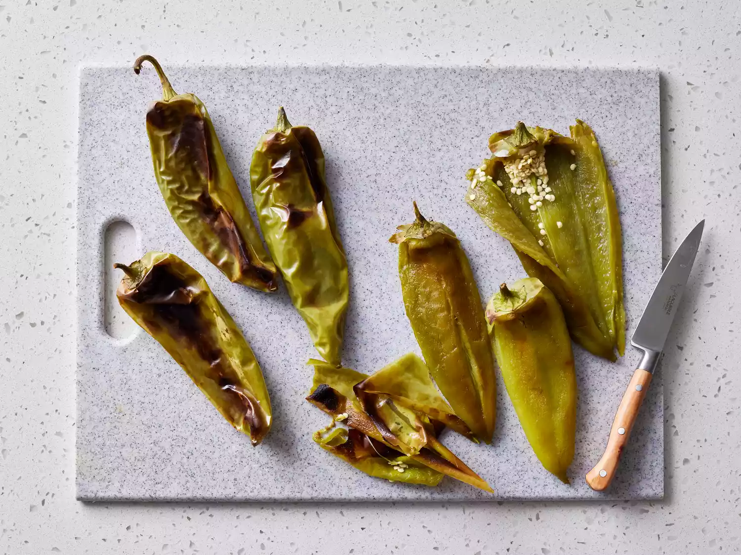 skin and seeds being removed from peppers 