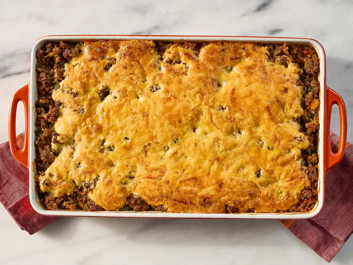 A baked dish of hot tamale pie in a rectangular casserole