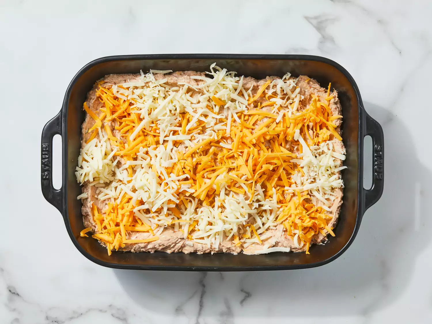 mixture transferred into a casserole dish and remaining cheese sprinkled over top