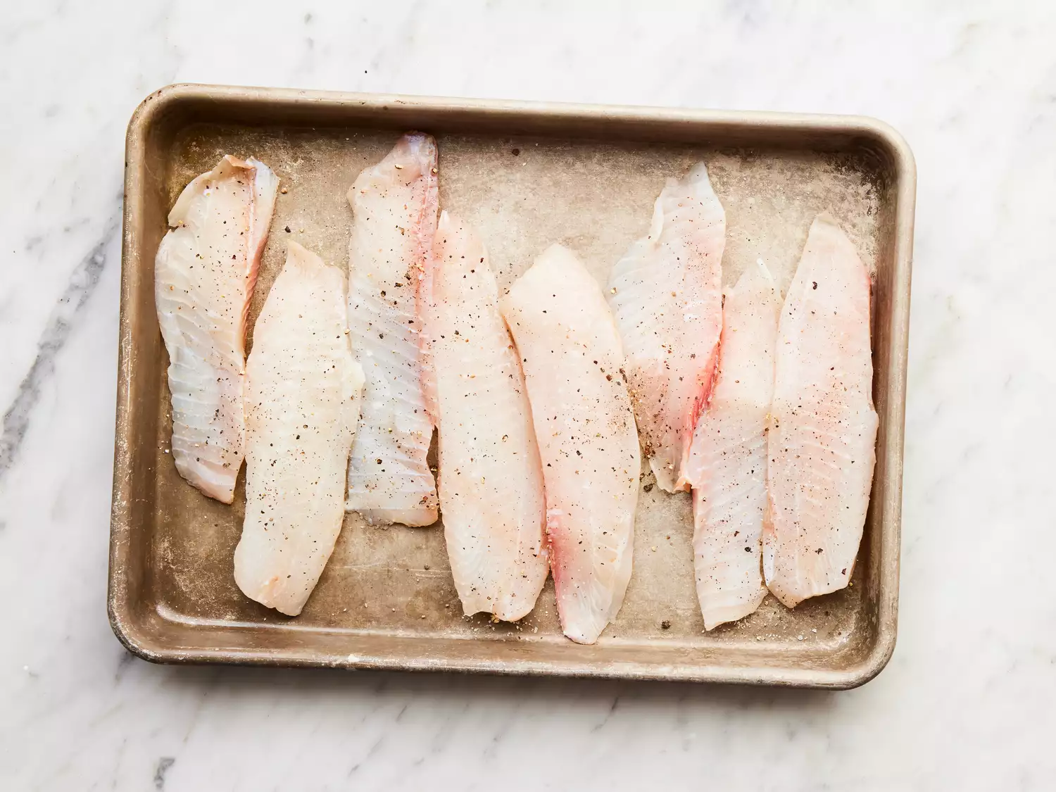 tilapia fillets seasoned with salt and pepper.
