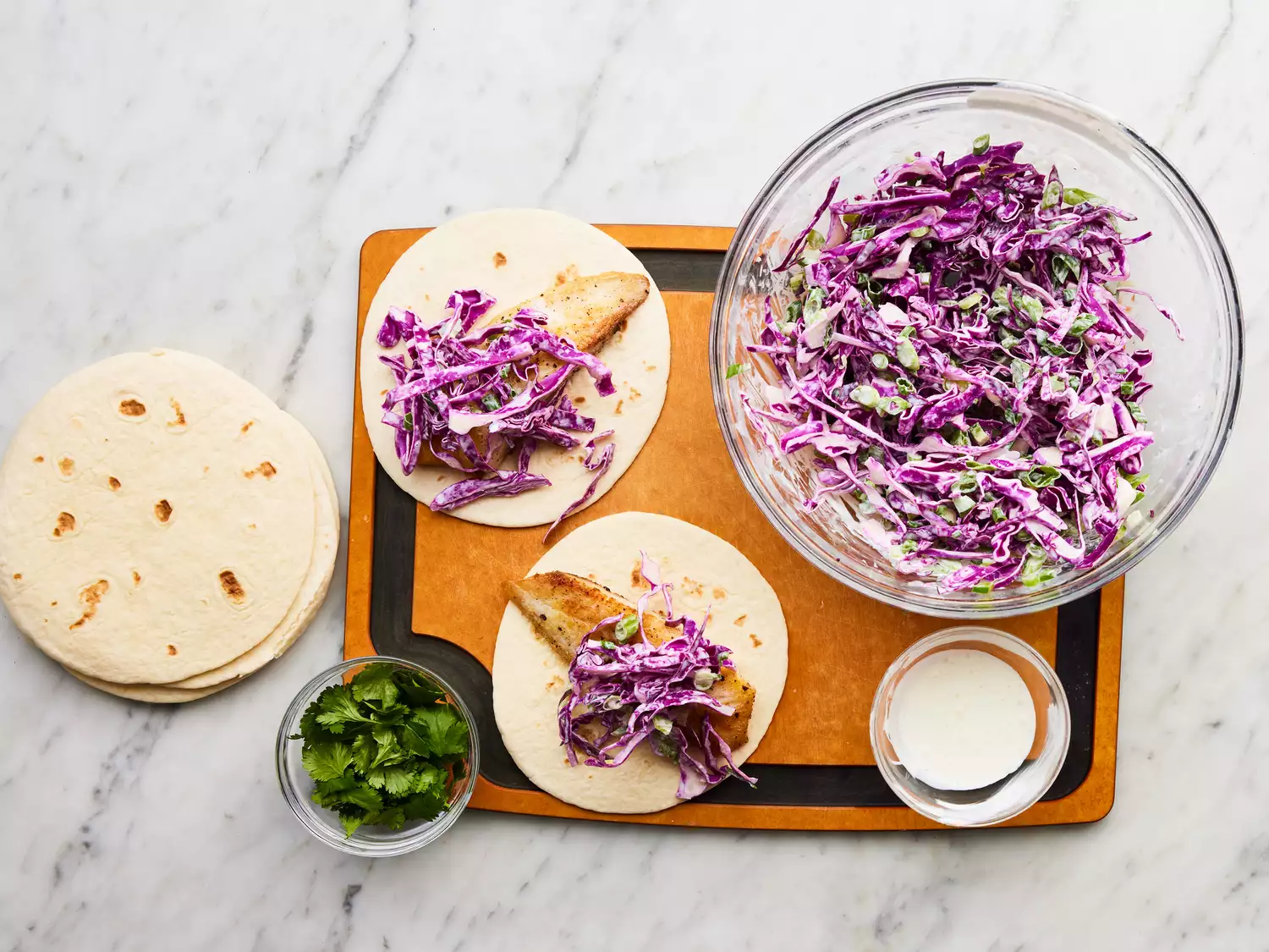 fish served with cabbage slaw, sour cream mixture and cilantro.