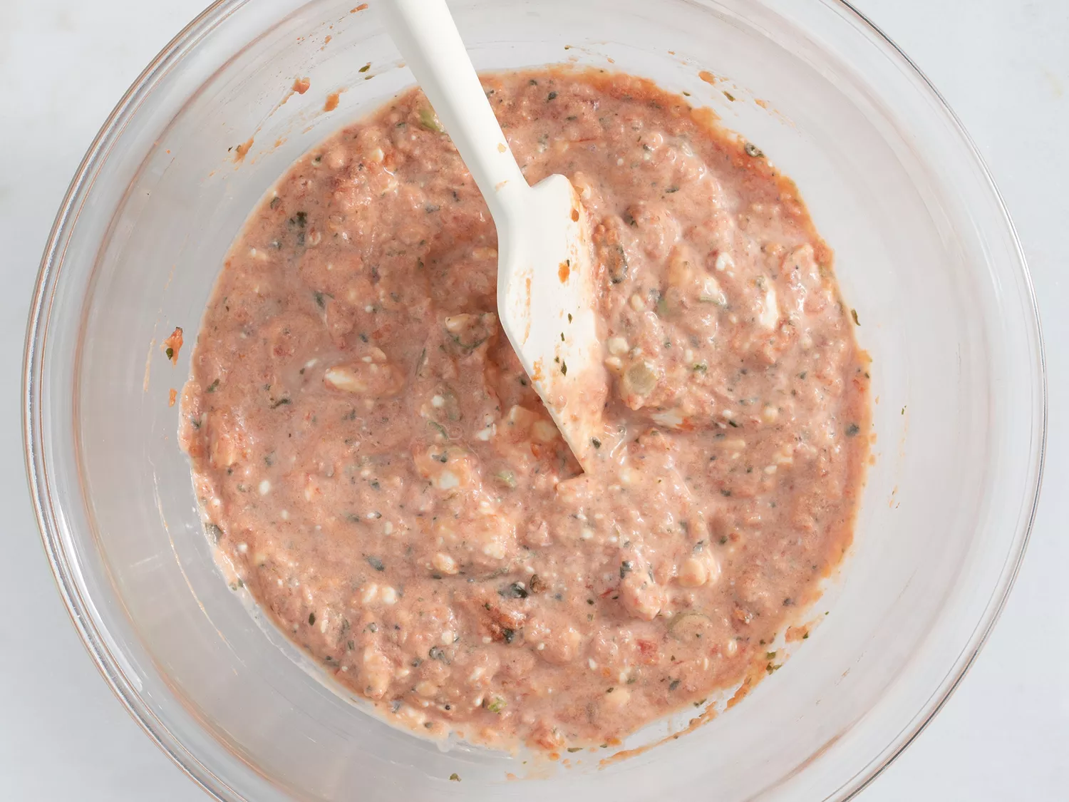 Salsa, cream cheese, and green onions mixed in a bowl