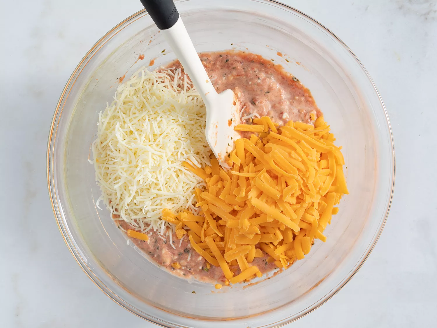 Cheddar cheese and Monterey Jack cheese incorporated into enchilada mixture 