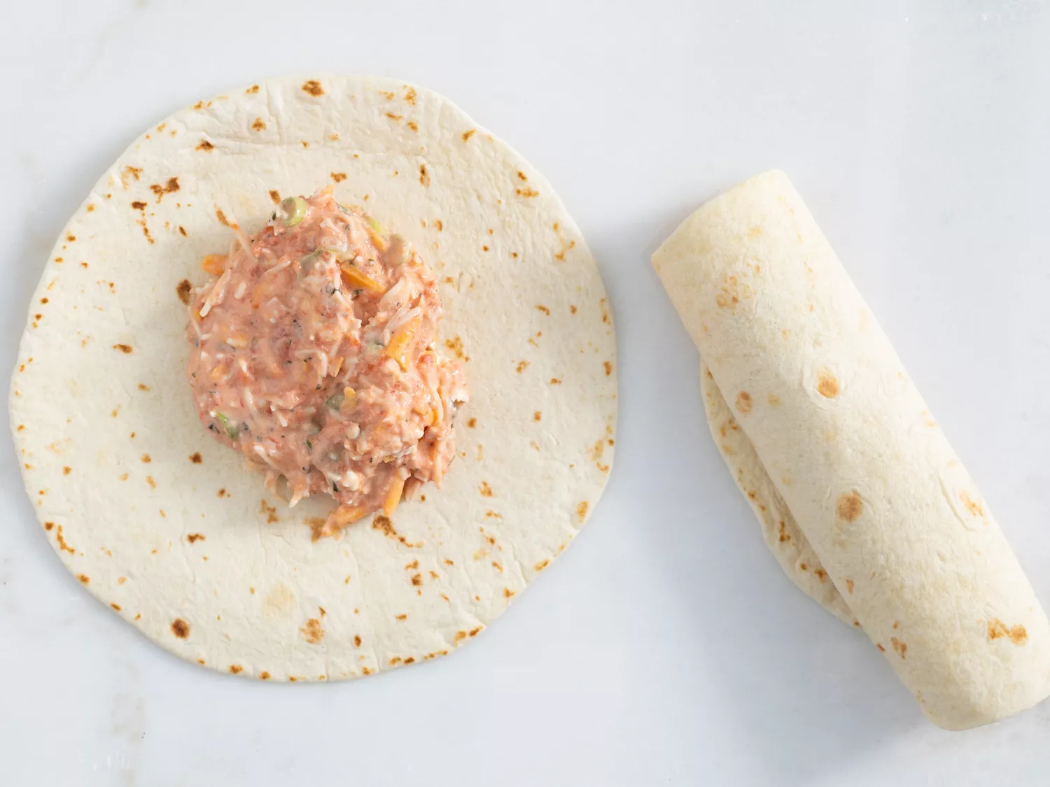 Cheese mix placed in center of flour tortilla and rolled up 