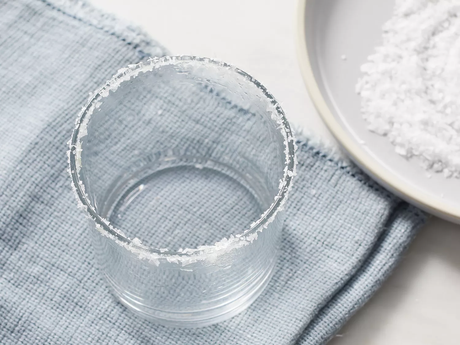 an overhead shot of a rocks glass with a salted rim