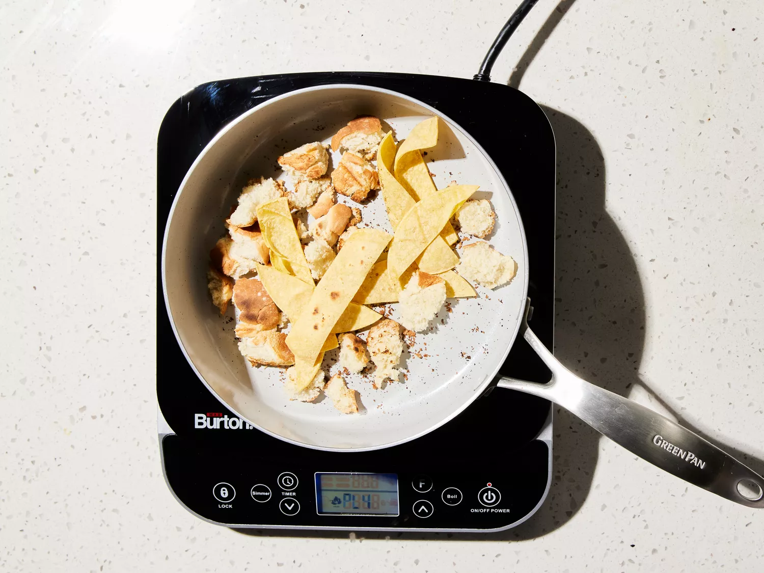 bread and tortilla pieces toasting in a pan