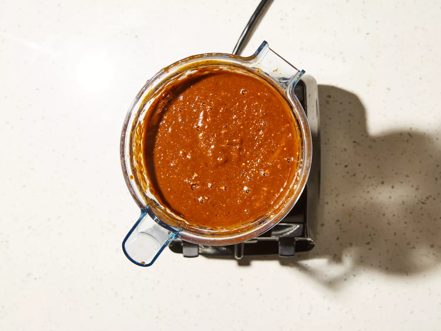 tomatoes placed in blender with chile mixture
