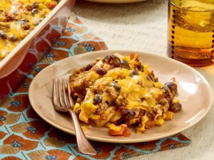 A slice of quesadilla casserole on a plate with a fork