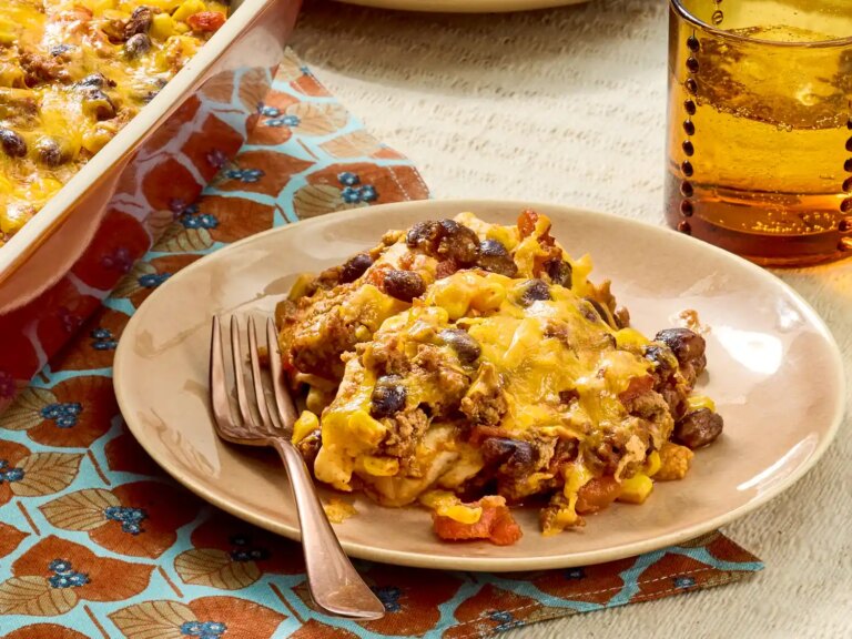 A slice of quesadilla casserole on a plate with a fork