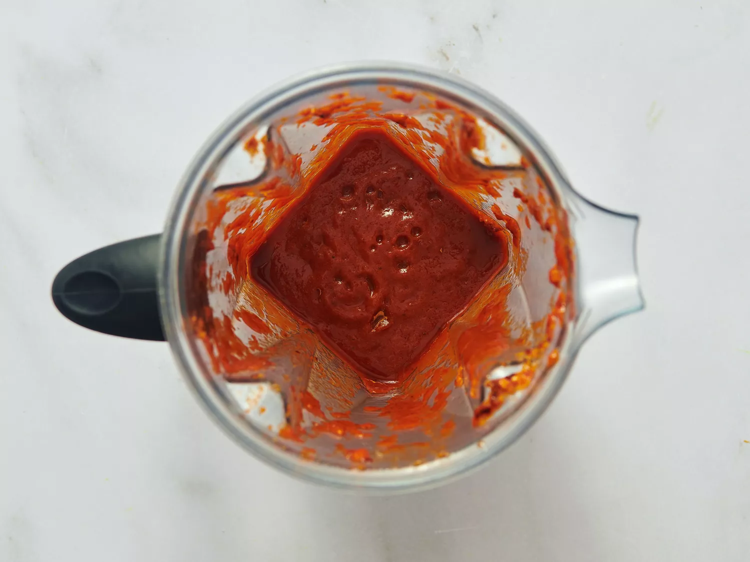 Red sauce mixture blended in a blender container