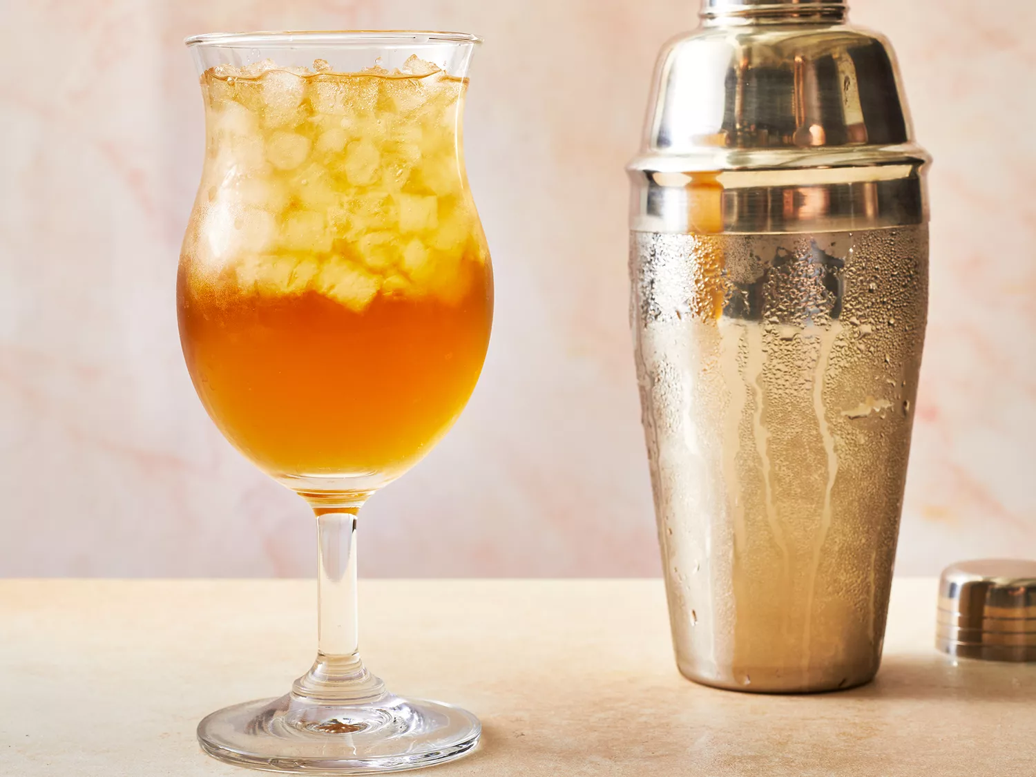 Long island iced tea poured into a hurricane glass.