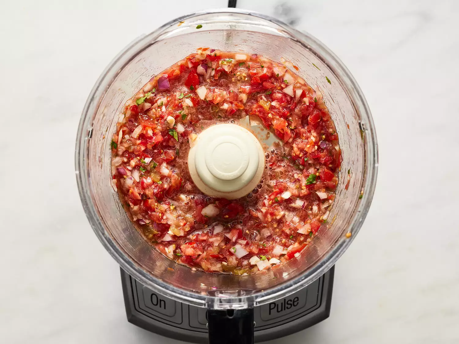 Blended salsa in a food processor. 