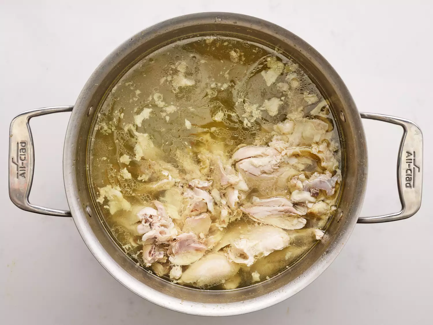 Cooked chicken in a pot with water 