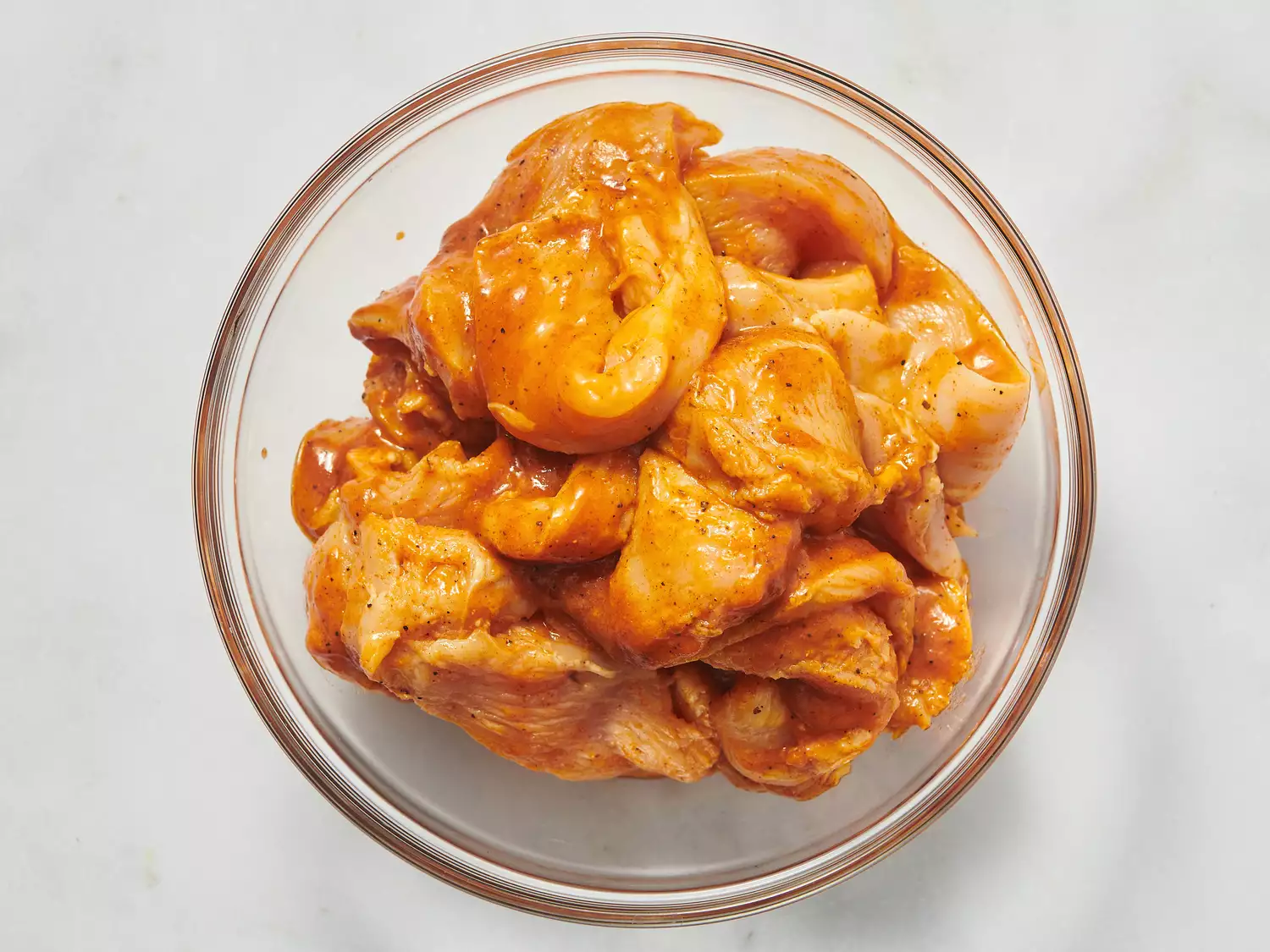 Chicken marinating in a bowl for fajitas