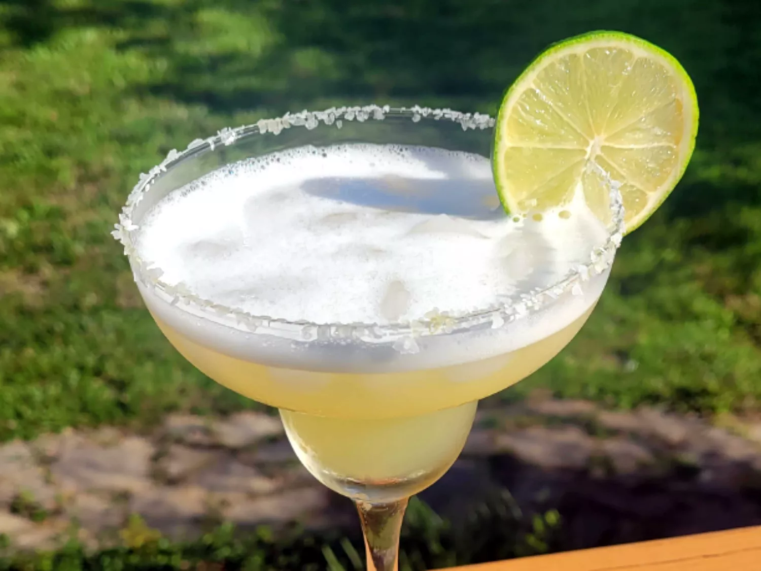 Presidente margarita with salt rim and lime slice