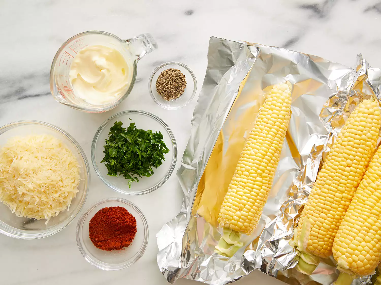 All ingredients gathered to make oven roasted parmesan corn on the cob.