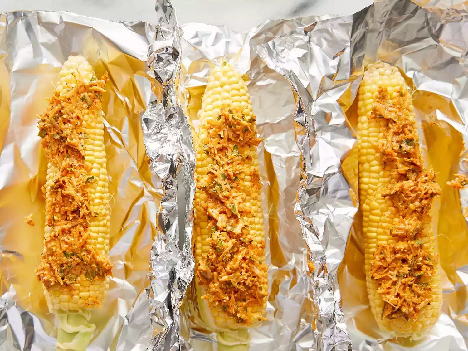 Paste rubbed on ears of corn, then wrapped in the aluminum foil.