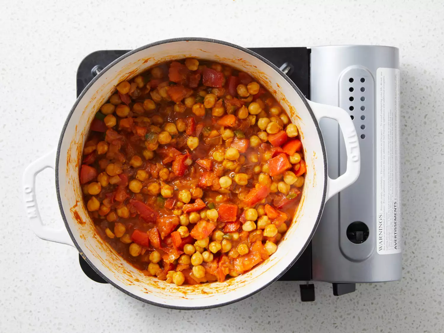 Chickpeas and tomato sauce have been added and stirred