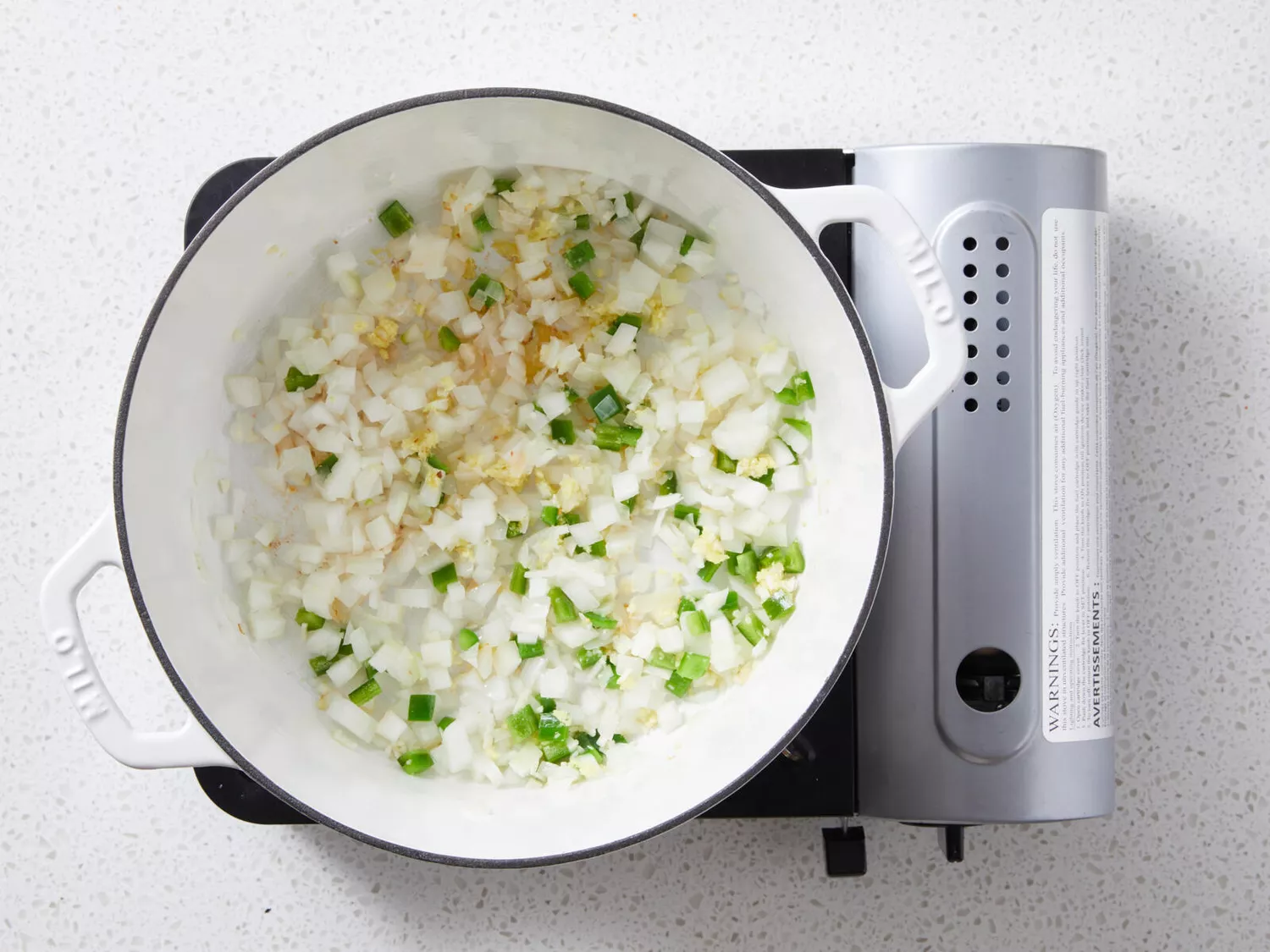 Sauted onion, garlic, ginger, and green onions in oil in saucepan