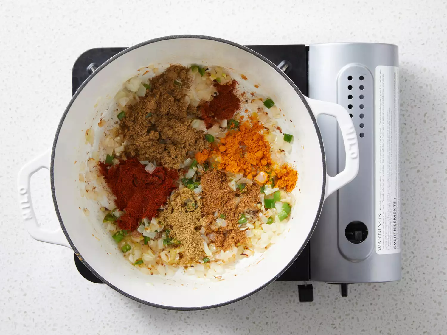 Onion mixture with cumin, paprika, coriander, garam masala, turmeric, and cayenne pepper