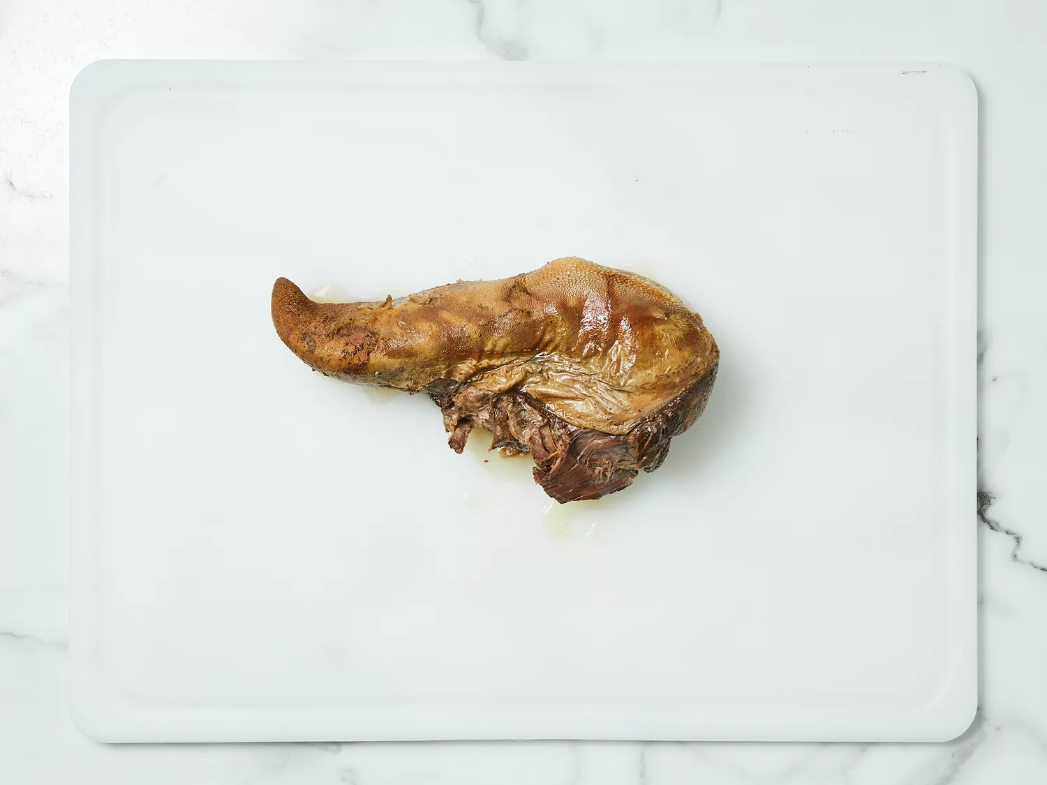 Tongue placed on a work surface to cool slightly.