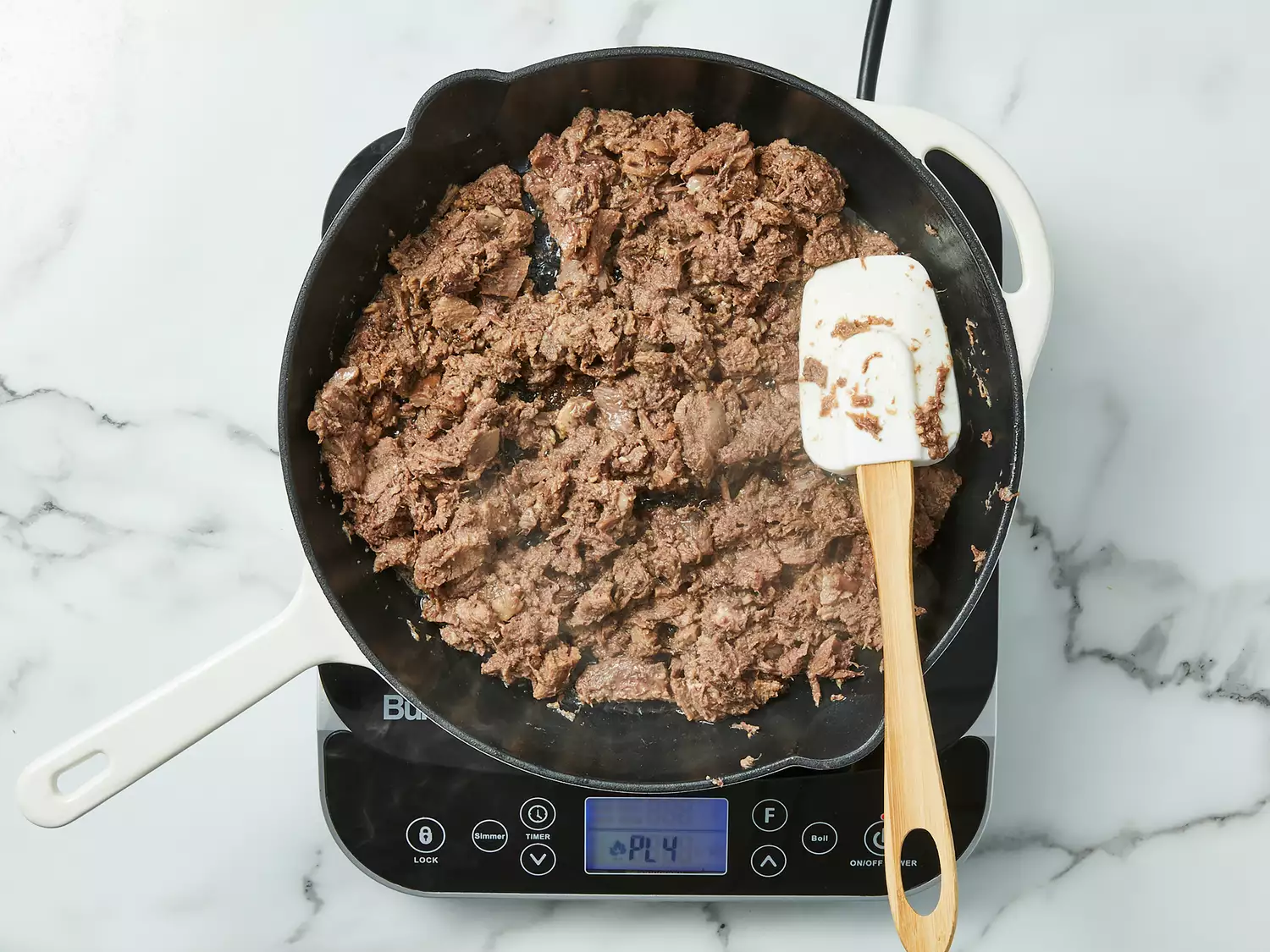 Chopped beef tongue cooking until tender.