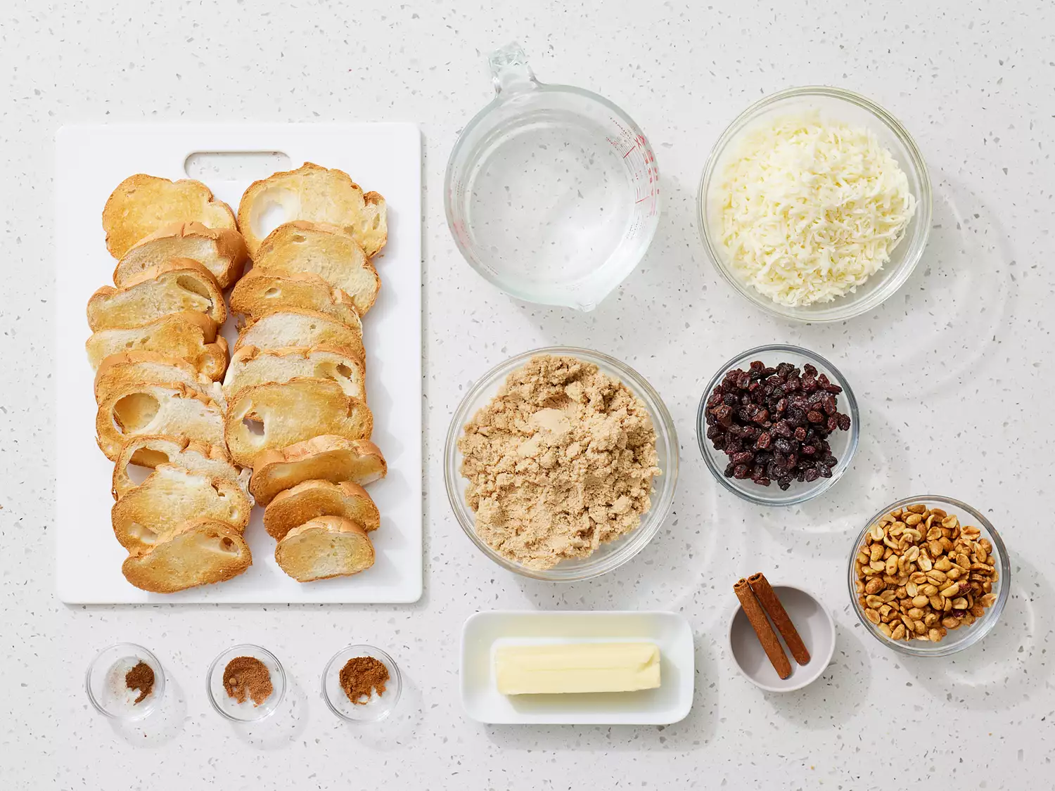 all ingredients to make a mexican-capirotada gathered on a kitchen counter. 