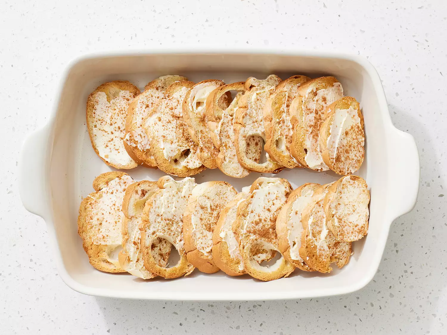 bread slices shingled into a casserole dish