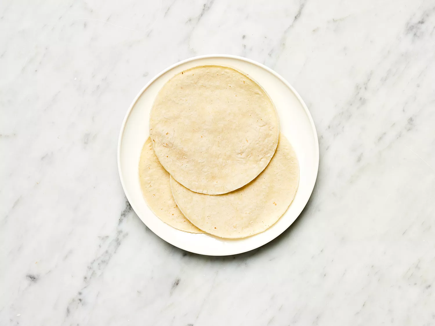 Corn tortillas on a white plate
