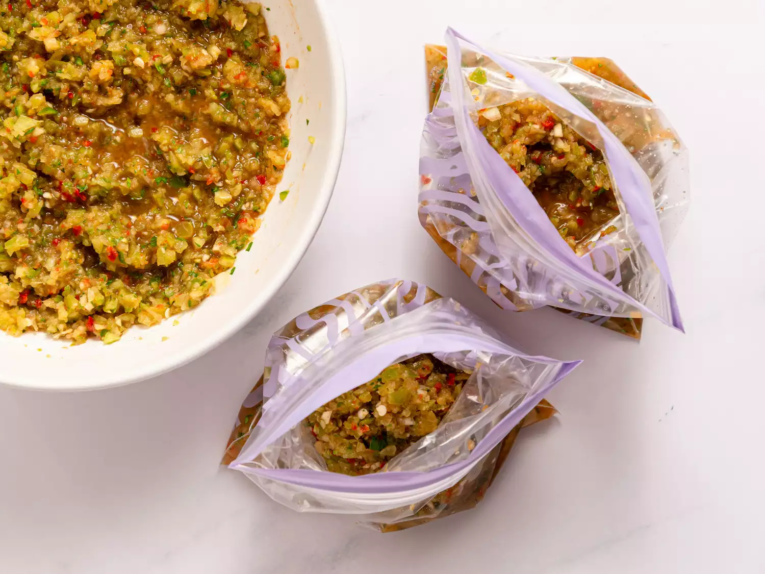 Spicy Green Tomato Salsa in a bowl and in plastic bags 