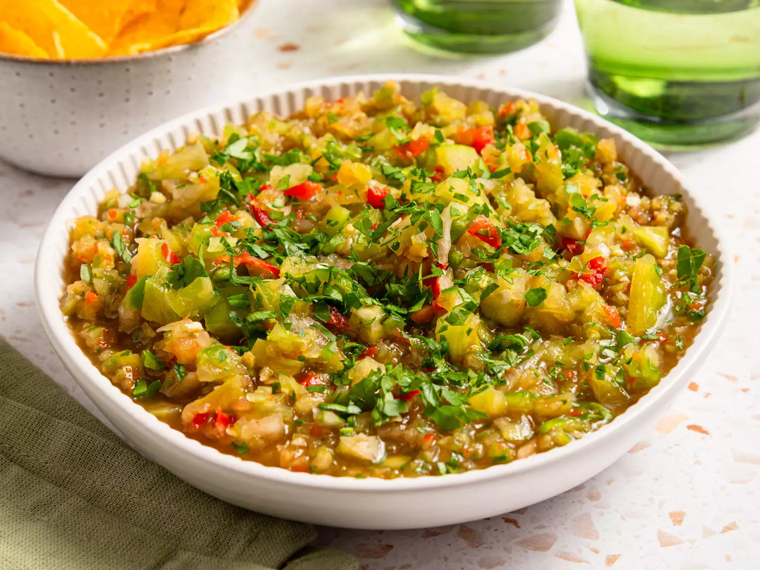 Spicy green tomato salsa garnished with cilantro in a bowl