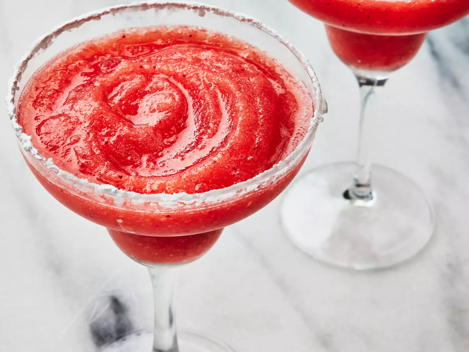 high angle looking at two strawberry margaritas