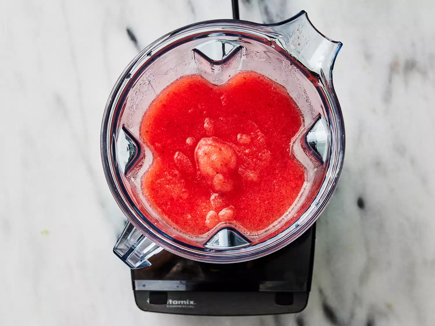Overhead of a blender with a fully blended margarita mix inside. 
