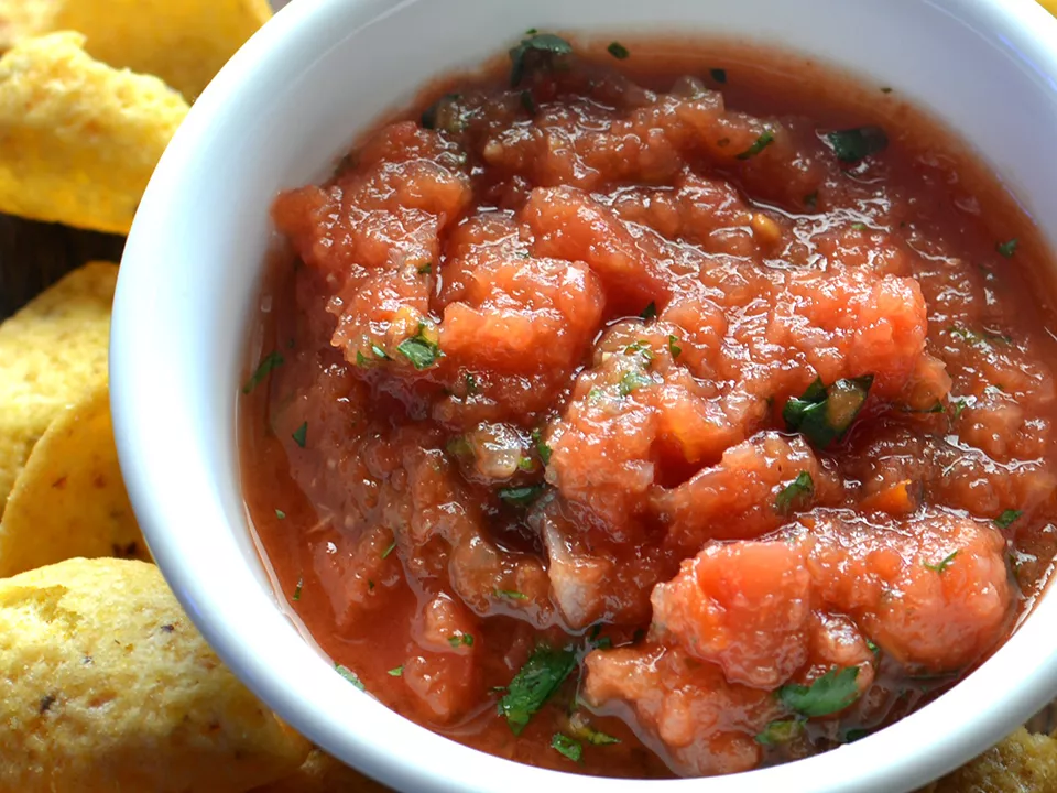 White bowl of roasted tomato salsa