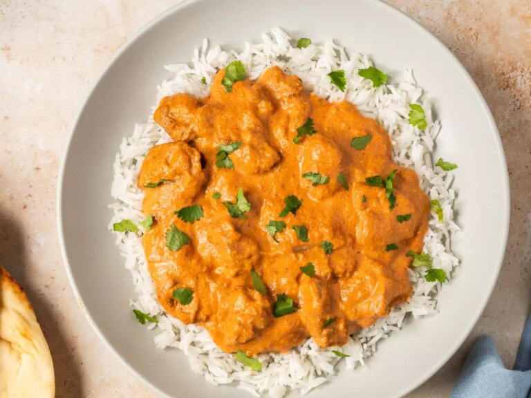 Butter chicken served on rice with garnish