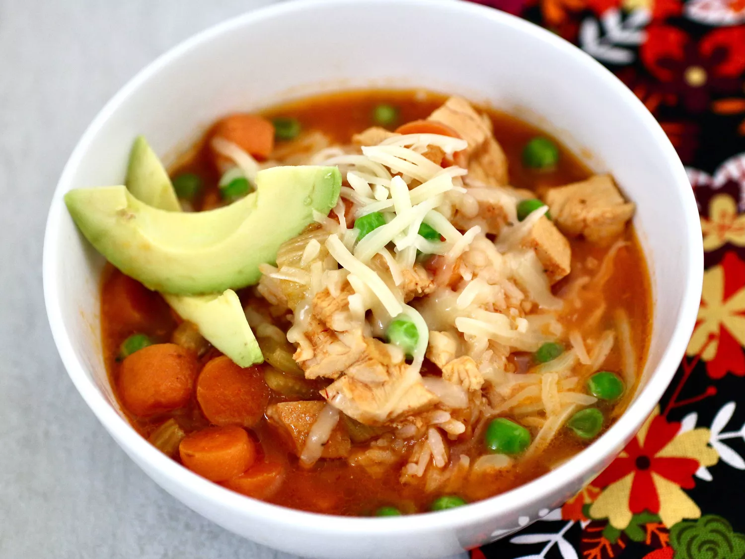 Mexican chicken rice topped with avocado and cheese