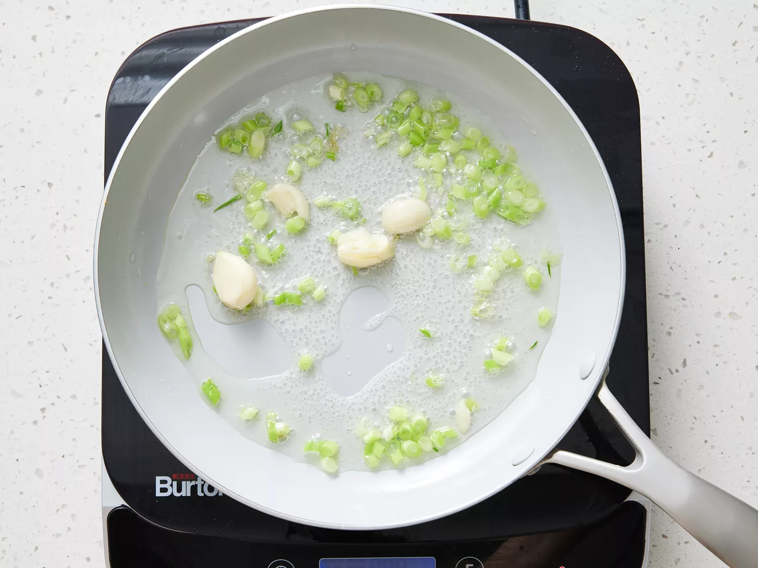 onions and garlic sautéing in a pan 
