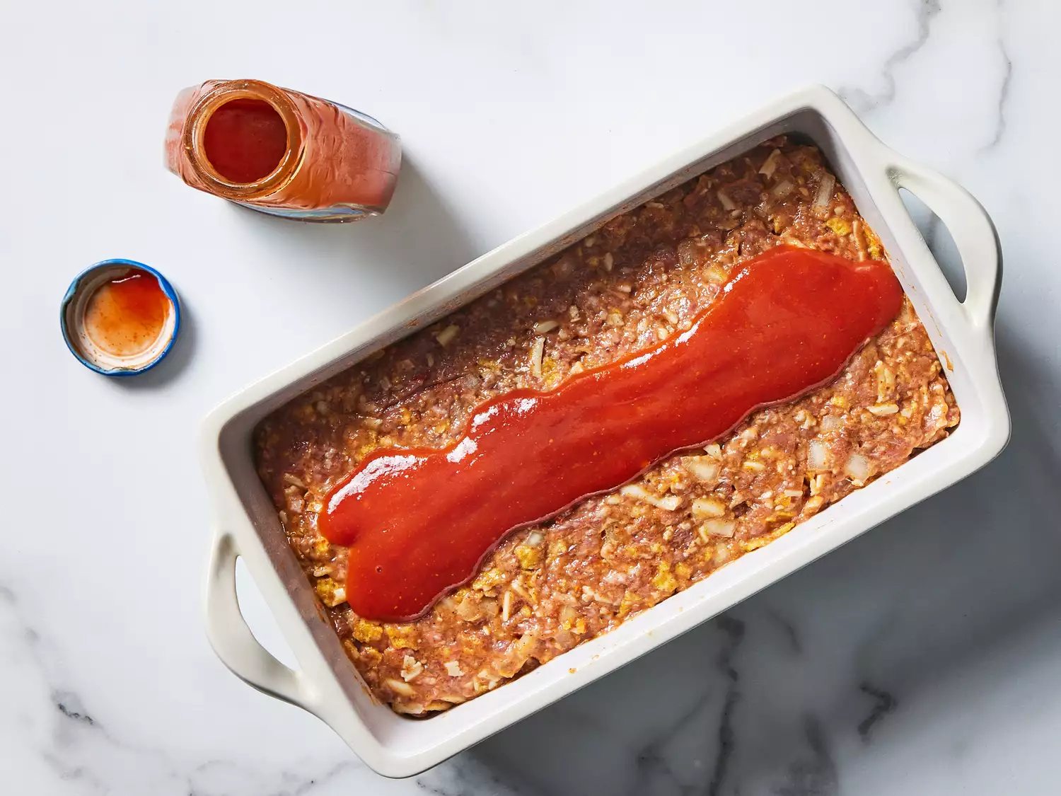 mixture pressed into a loaf pan and ketchup poured on top