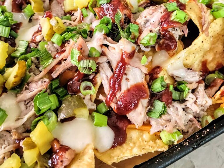 Loaded pulled pork nachos on baking sheet
