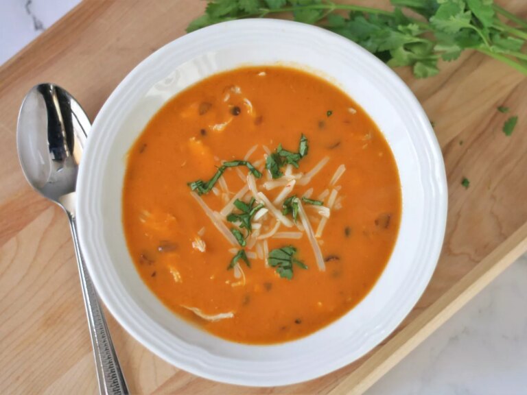 Tomato based tortilla soup with cheese