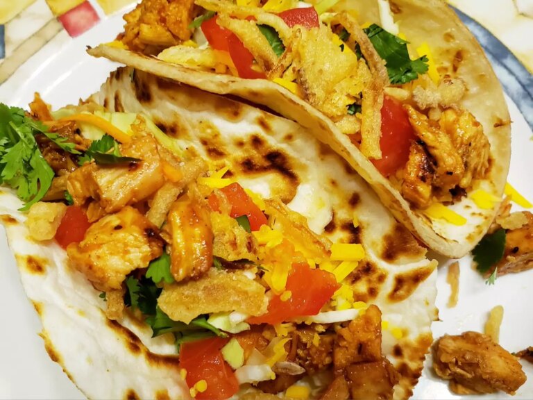 Close up of chicken with bbq sauce in flour tortillas