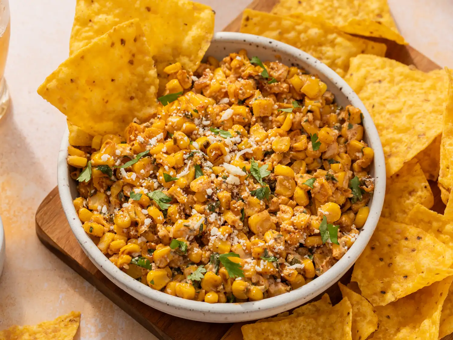 Mexican street corn dip served in a bowl surrounded by tortilla chips