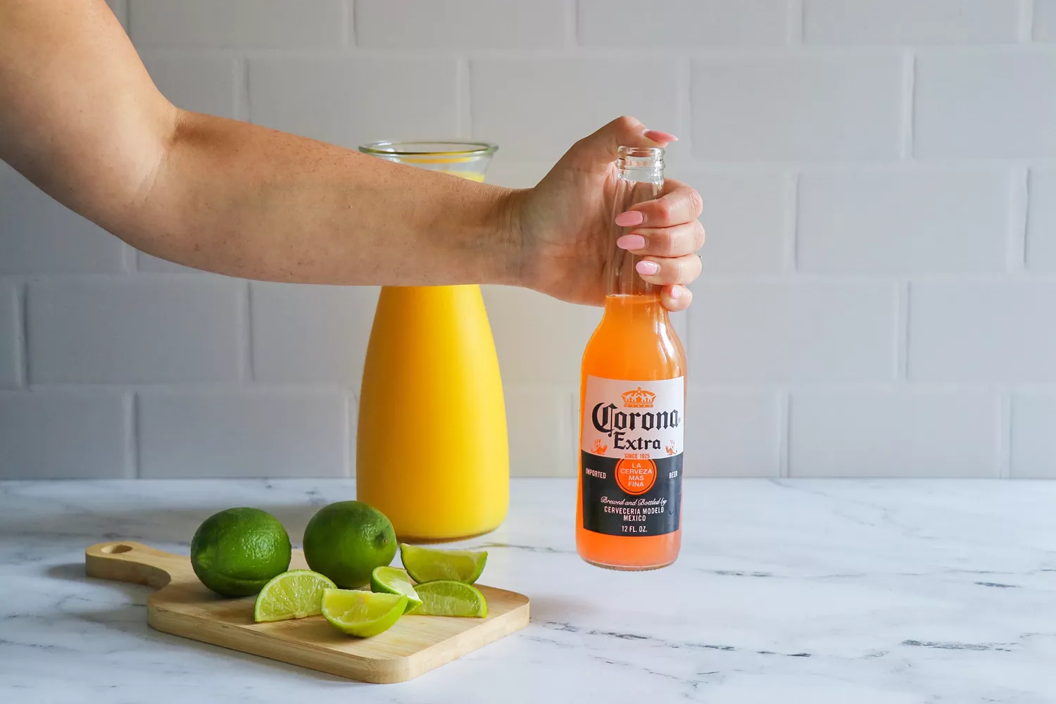 mixing all ingredients for a Corona sunrise in a Corona battle. 