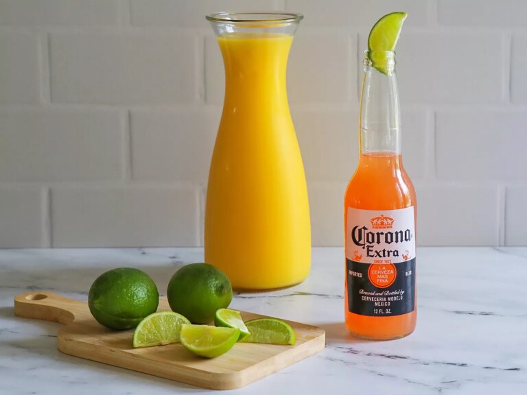 Corona sunrise with orange juice and lime in the background