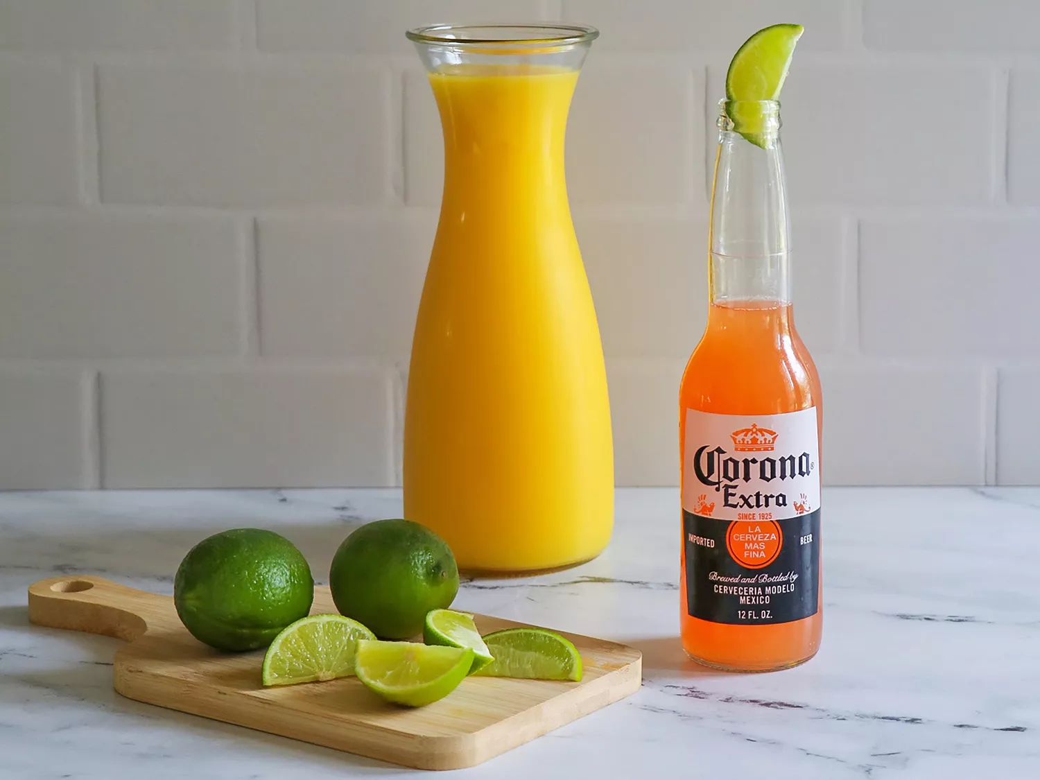 Corona sunrise with orange juice and lime in the background