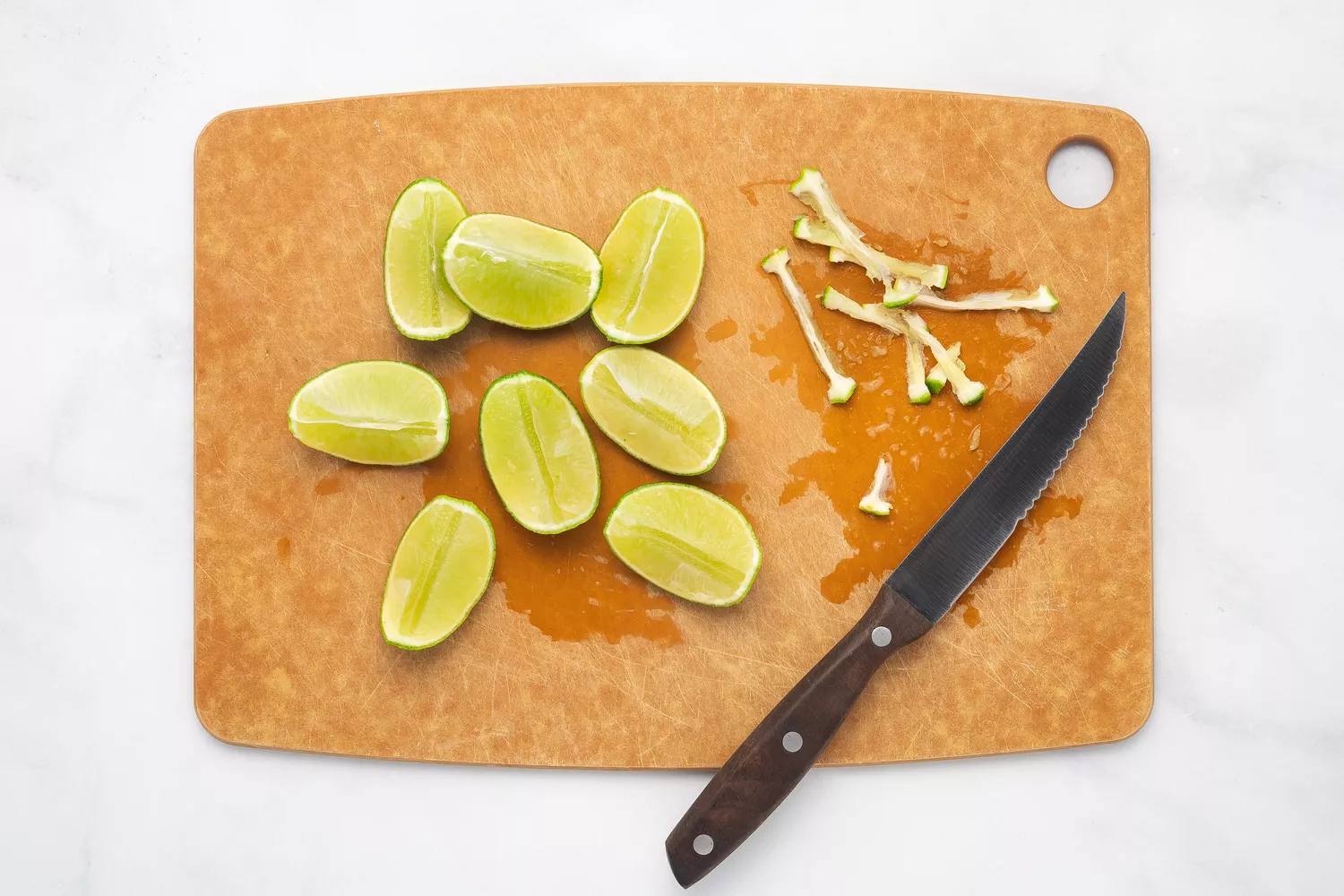 Sliced limes on a cutting board.