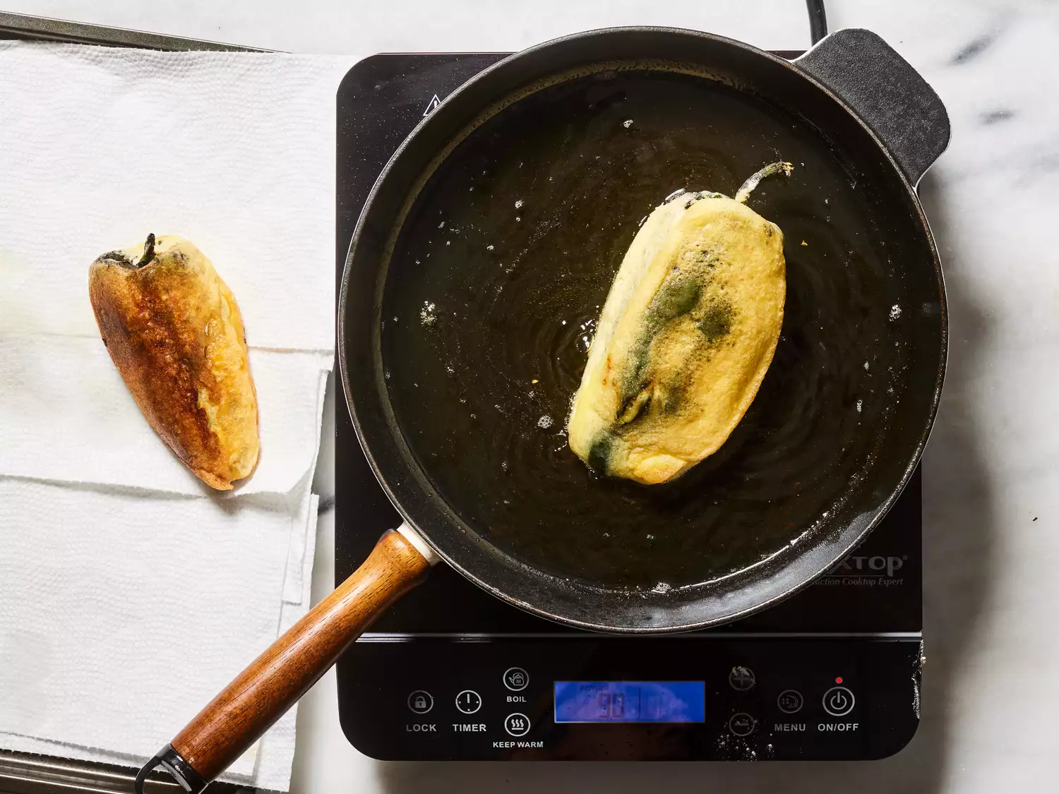 chiles fried until golden and placed on paper towel to drain