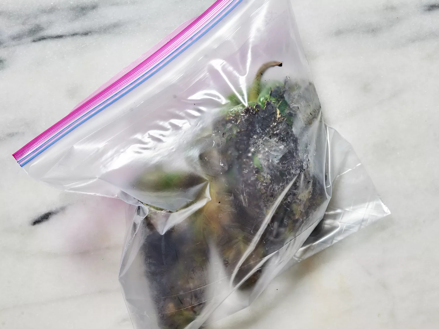 roasted peppers sweating in a bag