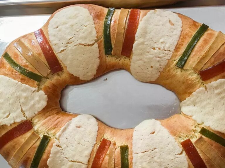 Close up view of a rosca de reyes round bread loaf on a baking sheet